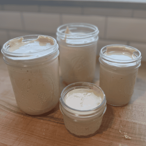 Allergy-friendly homemade marshmallow fluff in glass jars, gluten, dairy, and egg-free, with no corn.