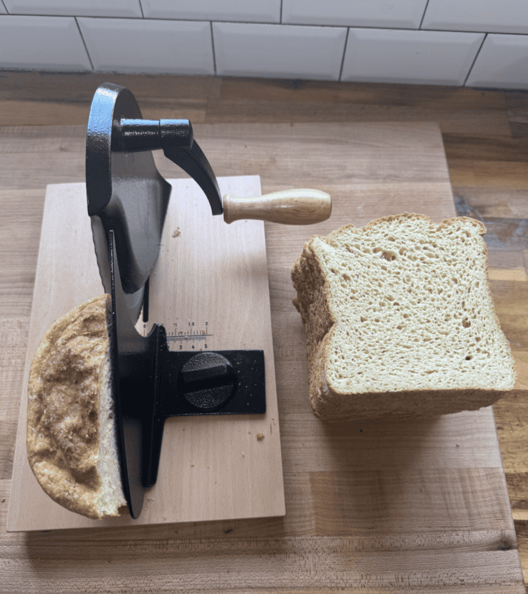 Gluten-free bread being sliced with a bread machine and slicer.