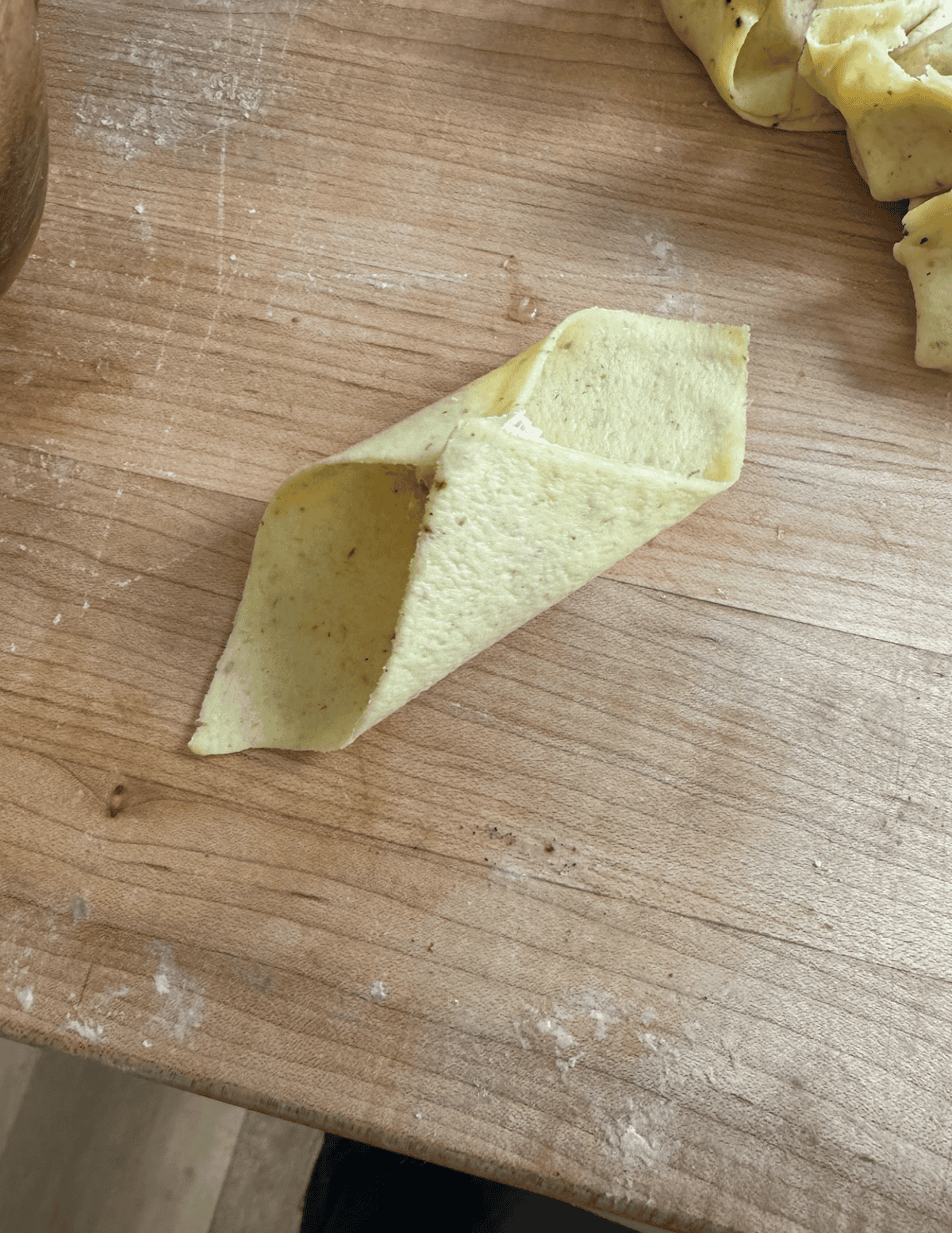 Shaping a gluten free rangoon by attaching opposite corners first.