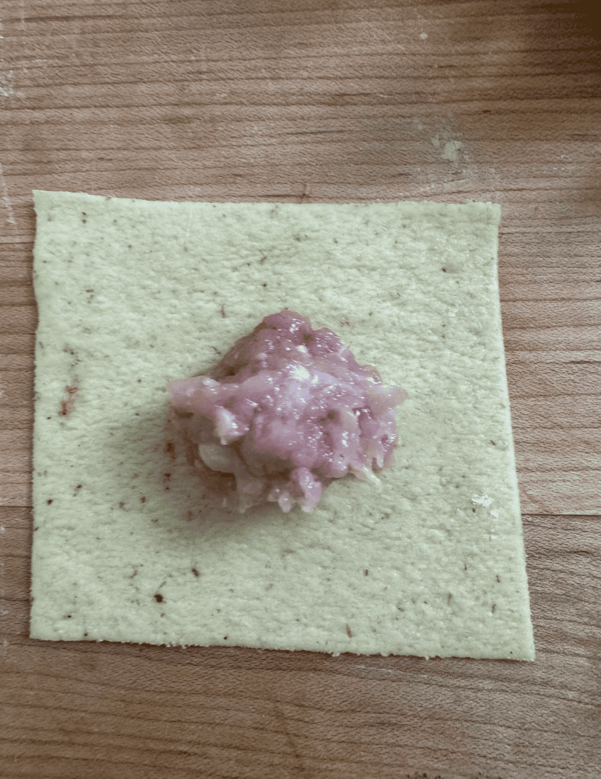 Fried Wonton Shaping Step 1 with meat inside the square wrapper dough.
