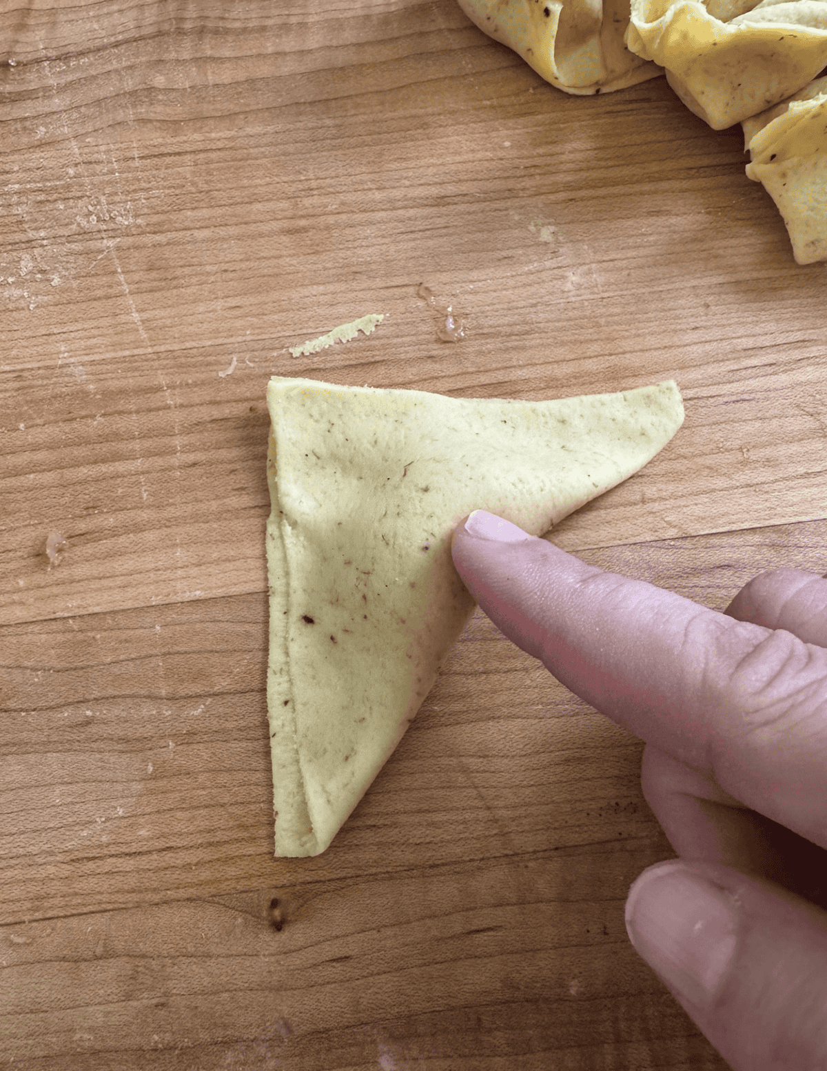 Fried Wonton Shaping Step 4 push in the meat area to create a foldable area.