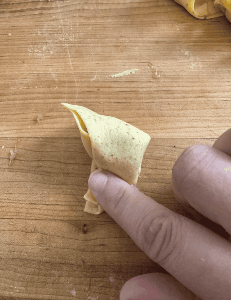 Fried Wonton Shaping Step 6 pinch the sides that are meeting together to seal and hold the shape.