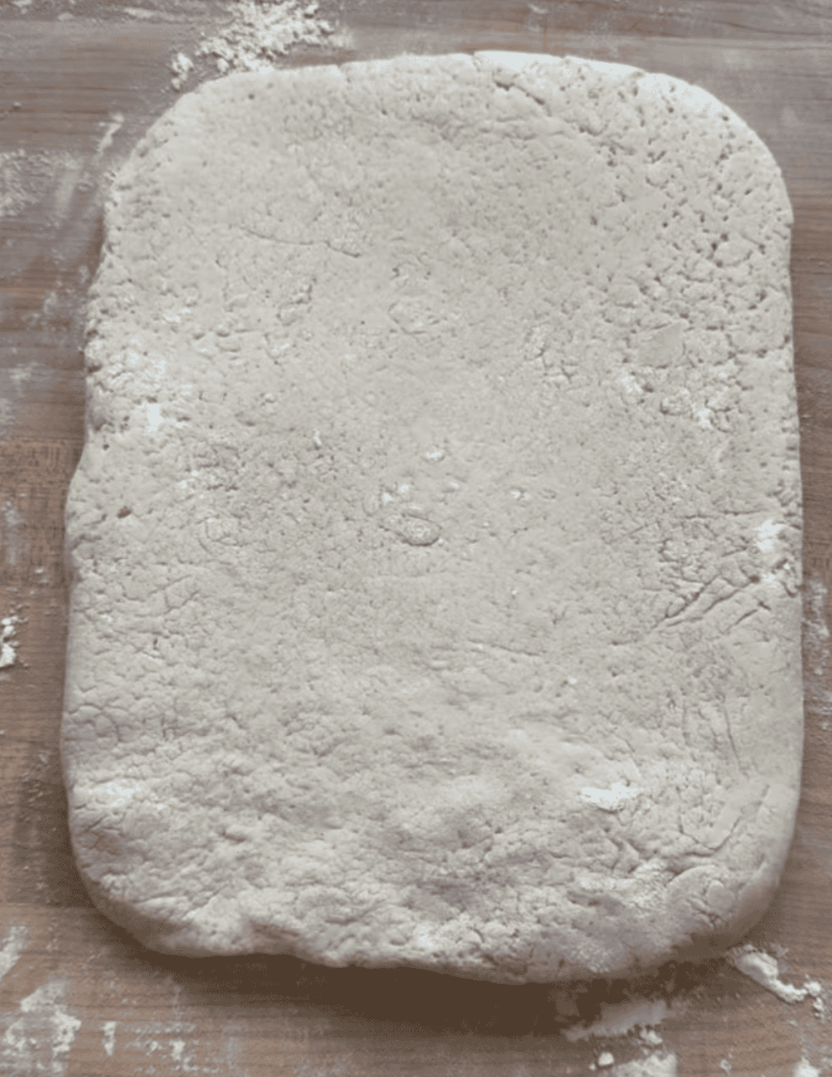 gluten free beignet dough rolled out into a rectangle.