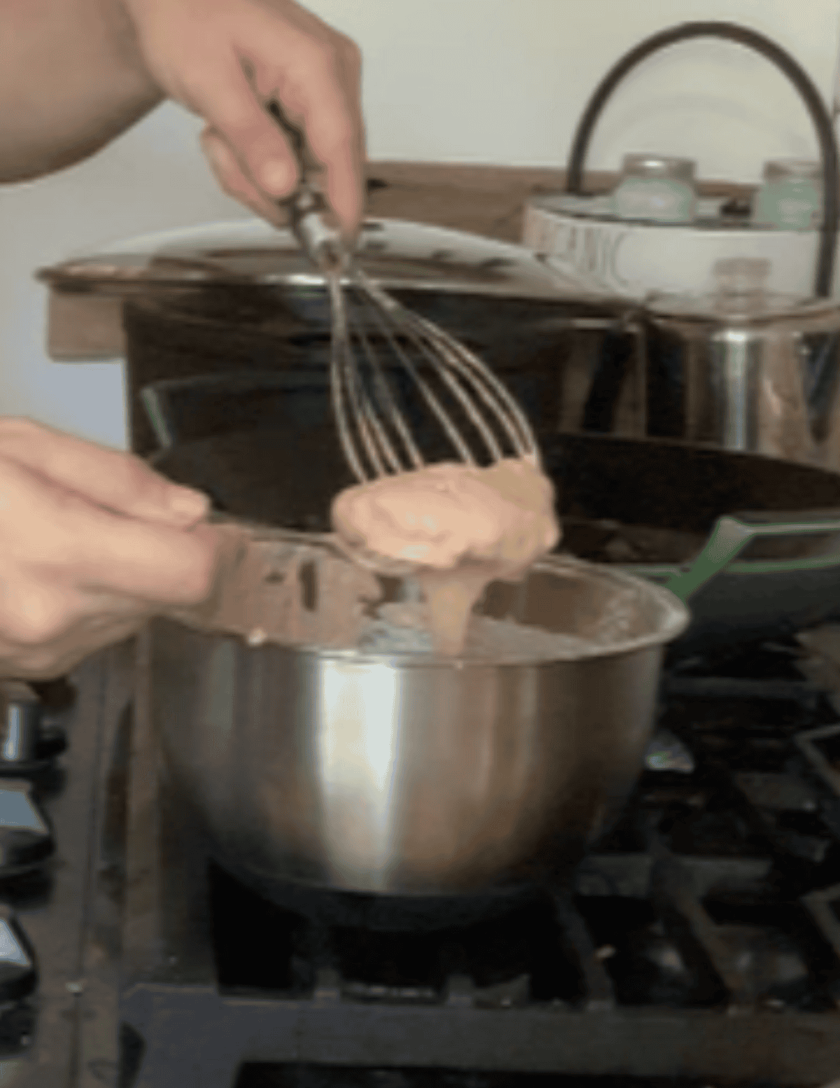 Gluten free nugget being dipped in a flour slurry to coat for frying.