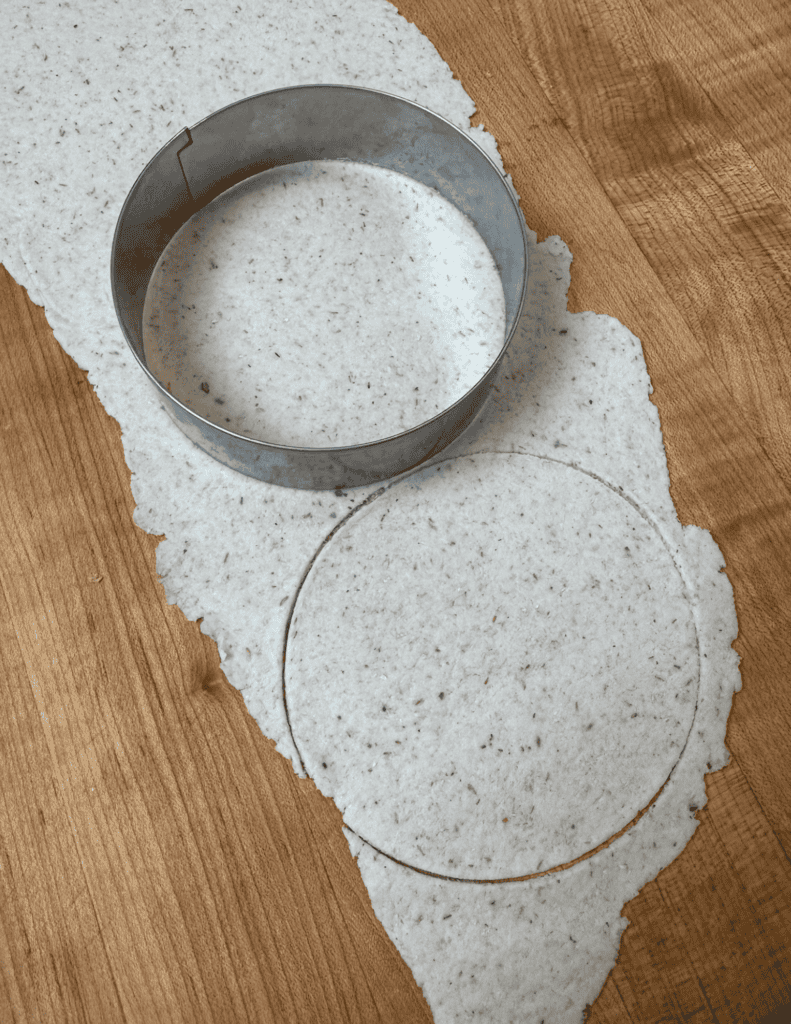 Gluten free dumpling dough making circle shapes in the rolled out dough