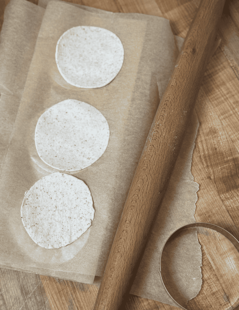 gluten free wonton wrappers lined on parchment paper