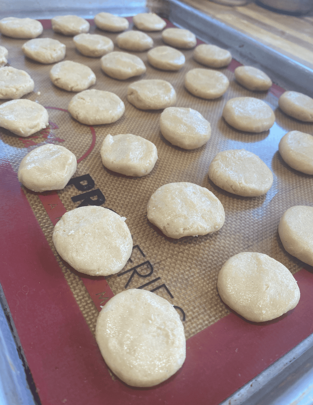 gluten free Nilla wafer cookies pre-baked on a silicone mat lined tray