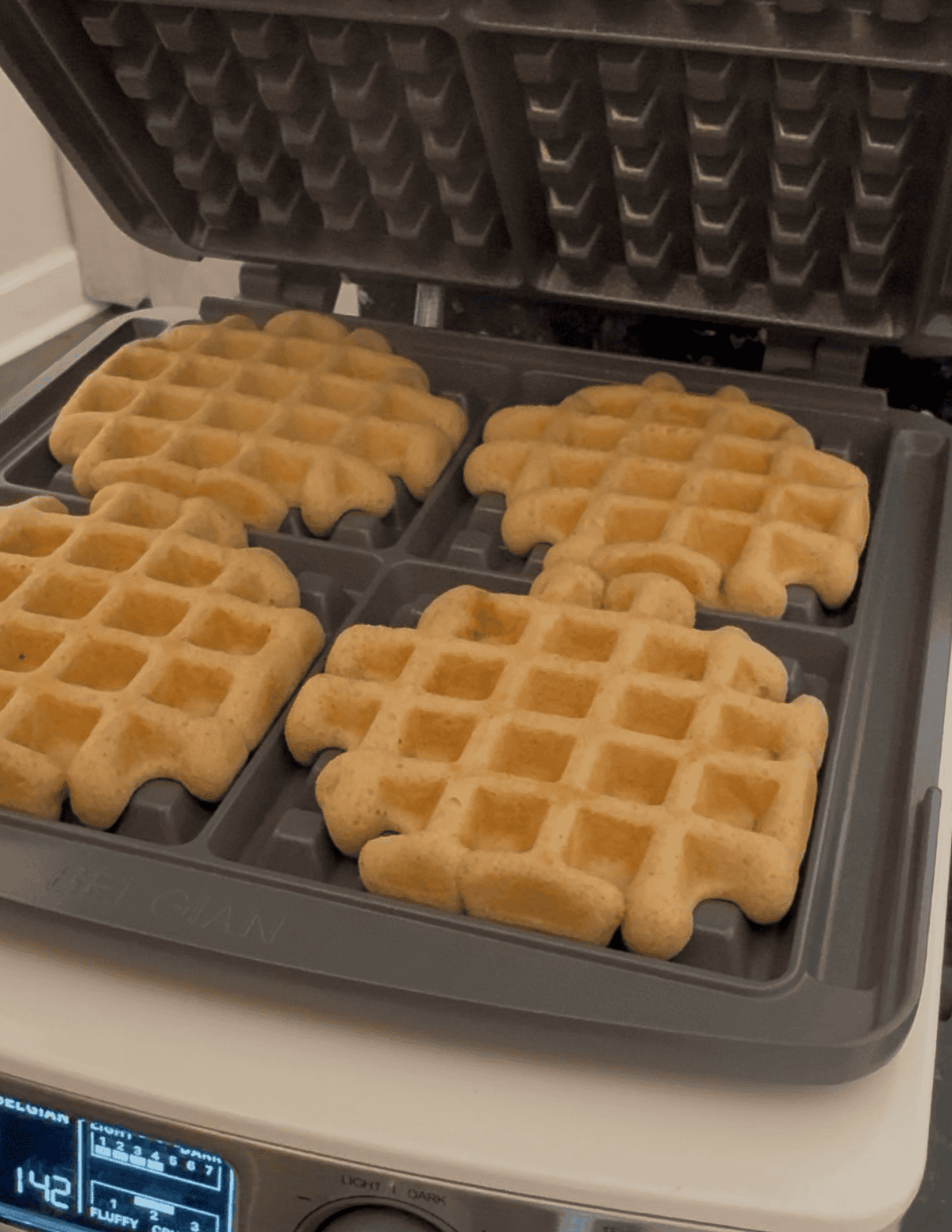Gluten free waffles on a waffle maker.