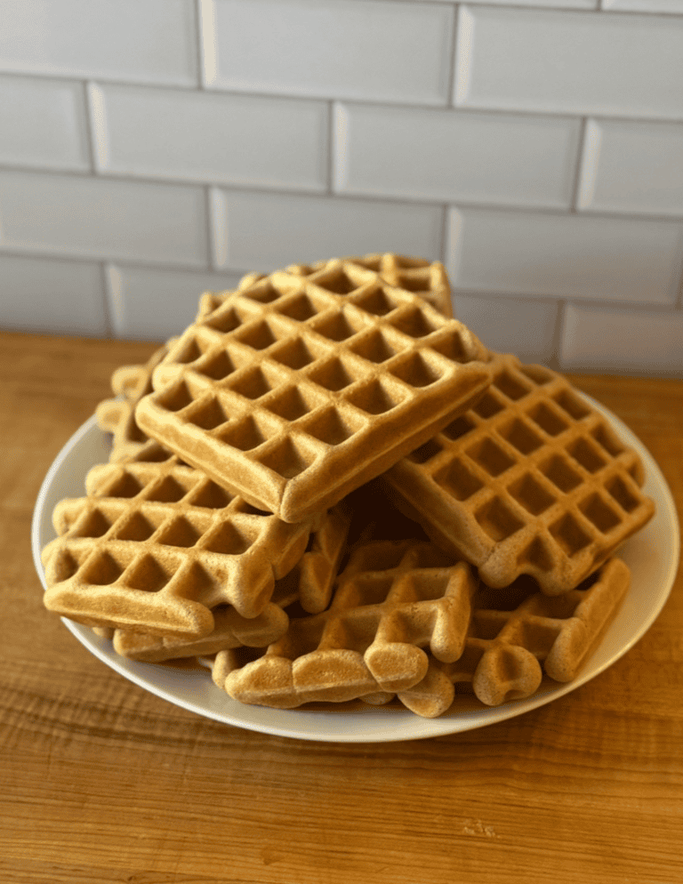 Gluten Free Waffles stacked onto a white plate.