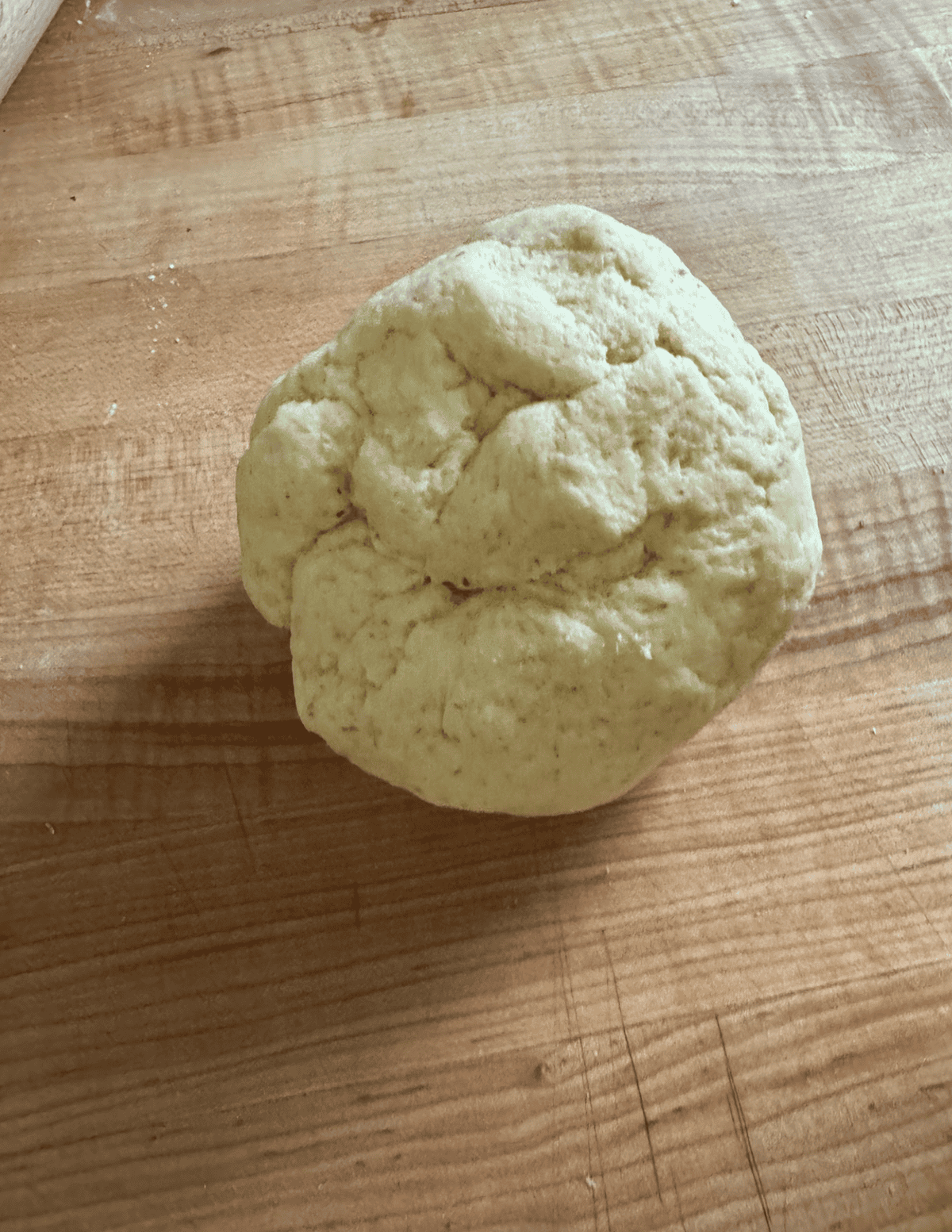 Wonton dough ball sitting on a counter.
