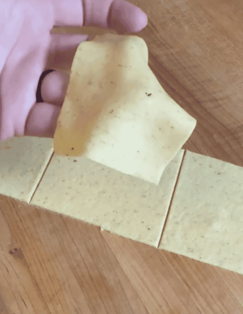 gluten free wonton wrapper squares showing off how soft it is.
