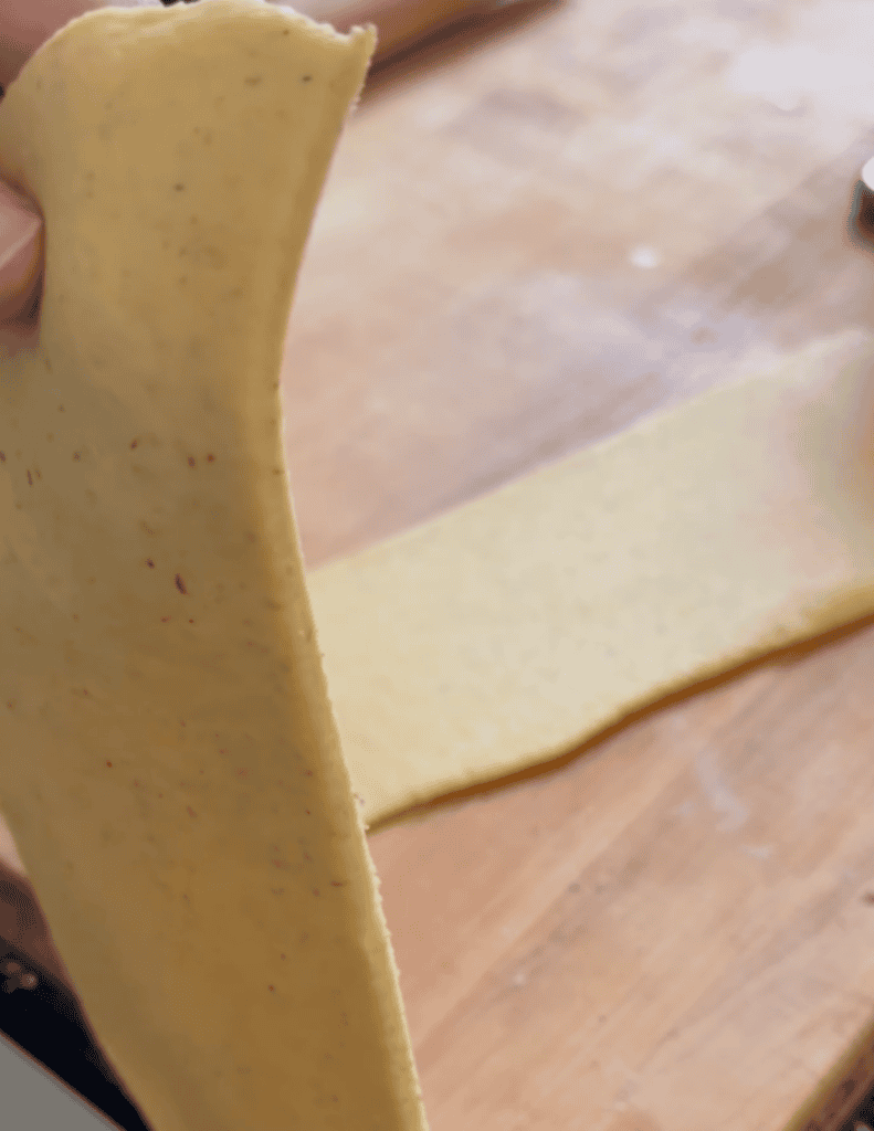 Wonton dough. Half being held up for thickness.