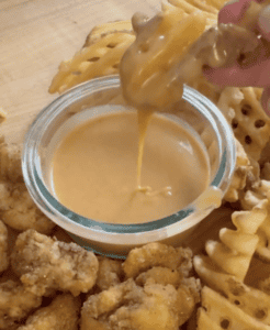 French fry being dipped in chickfila sauce