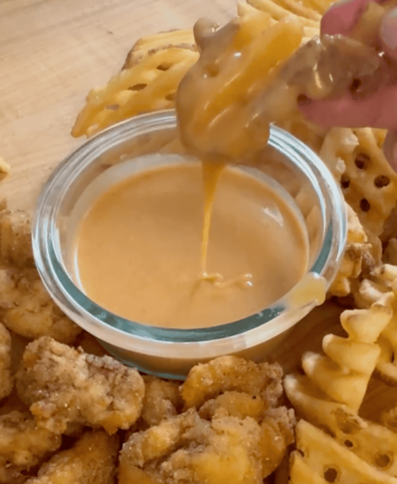 French fry being dipped in chickfila sauce 