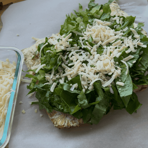 reverse chicken caesar salad with chicken, lettuce and parmesan cheese.