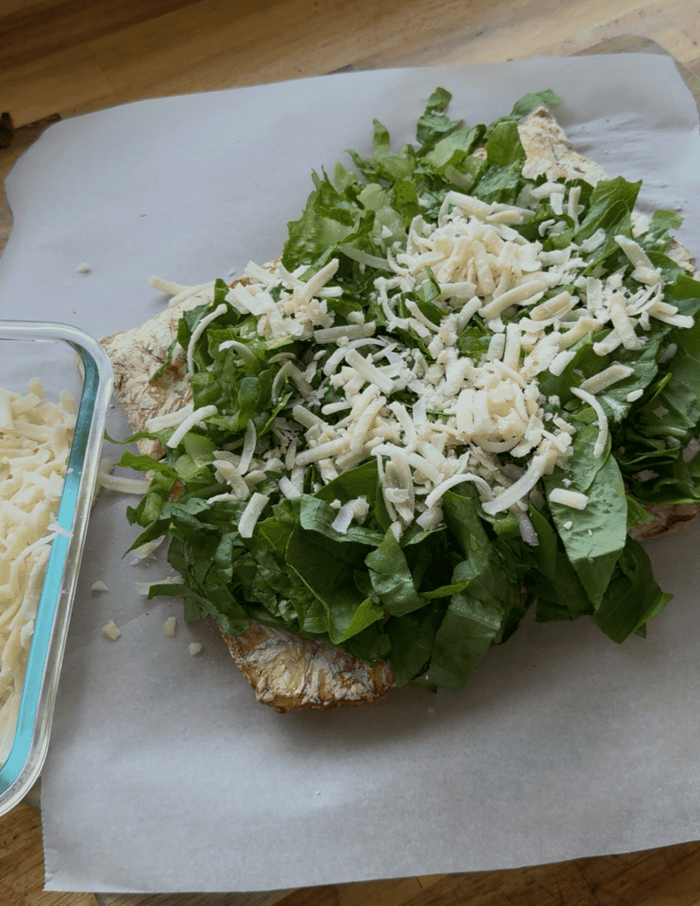 reverse chicken caesar salad with chicken, lettuce and parmesan cheese.