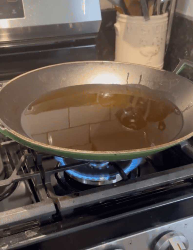 wok with oil frying on the gas stovetop