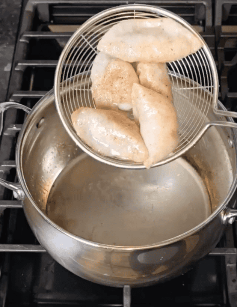 gluten free pot stickers recipe with pot stickers in the spider strainer.