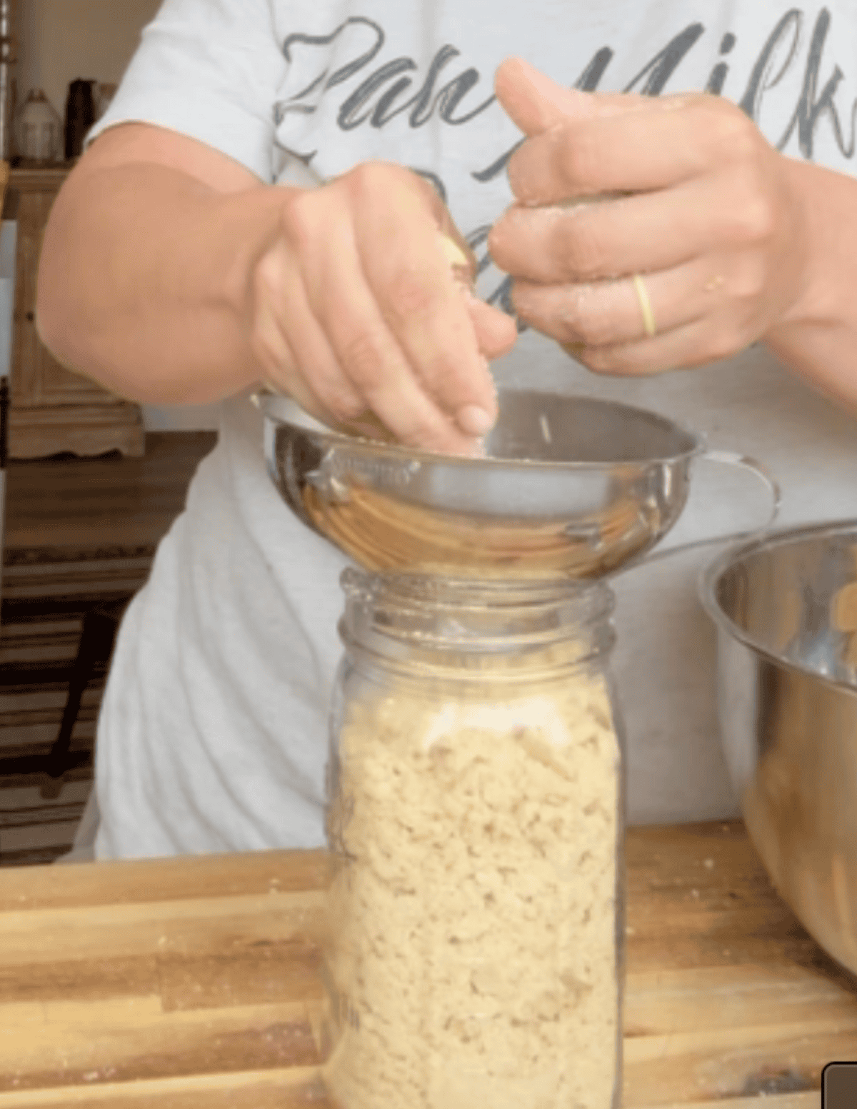 Nilla wafers being crushed into a jar.