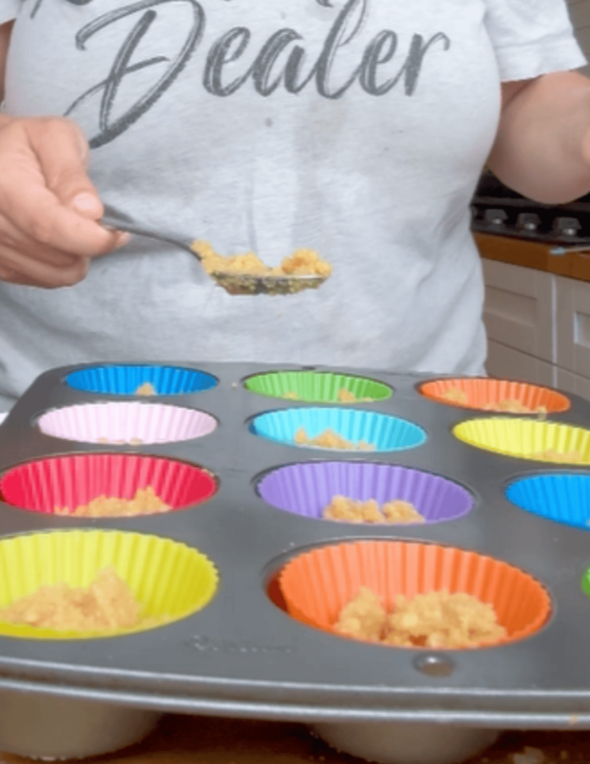 gluten free raspberry cheesecake bites being prepared with silicone cupcake liners in the pan.