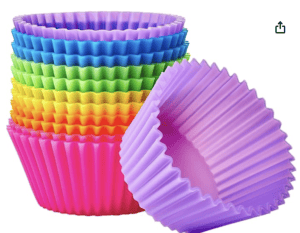 Colorful rainbow cupcake liners perfect for baking gluten-free raspberry cheesecake bites.