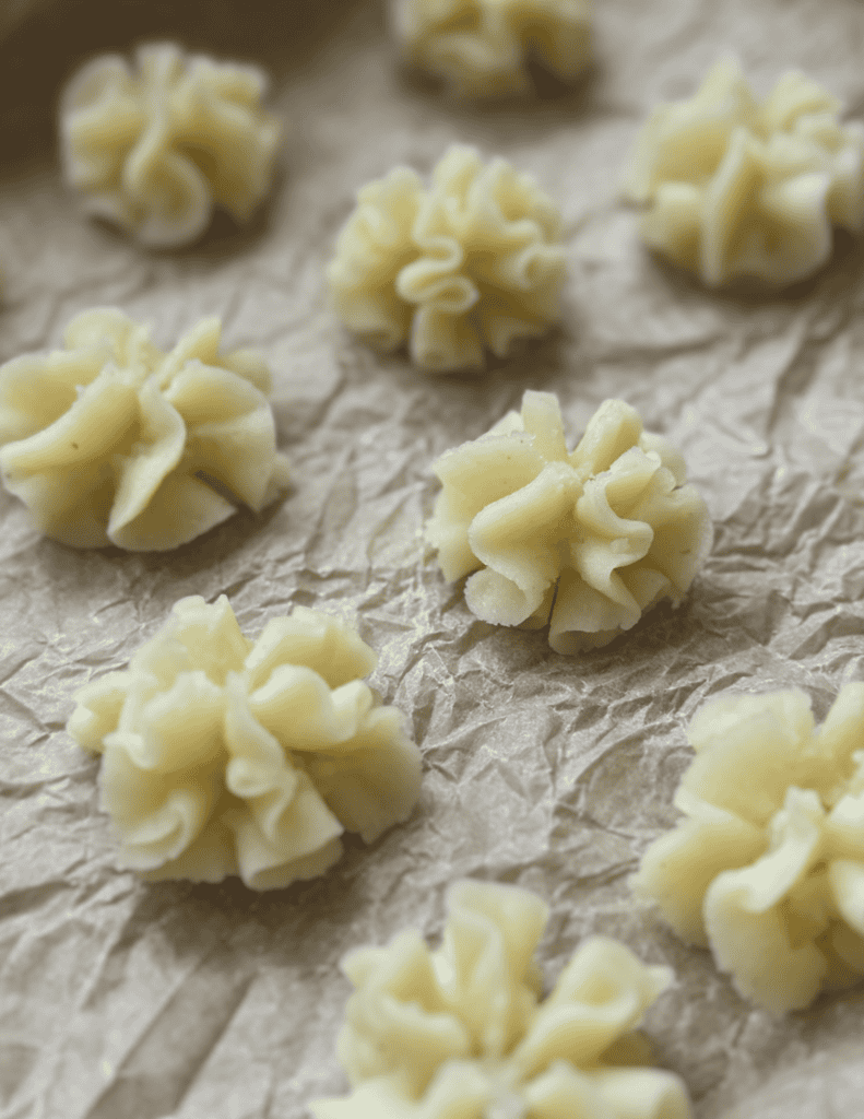 Handmade pasta with fresh ingredients on parchment paper.