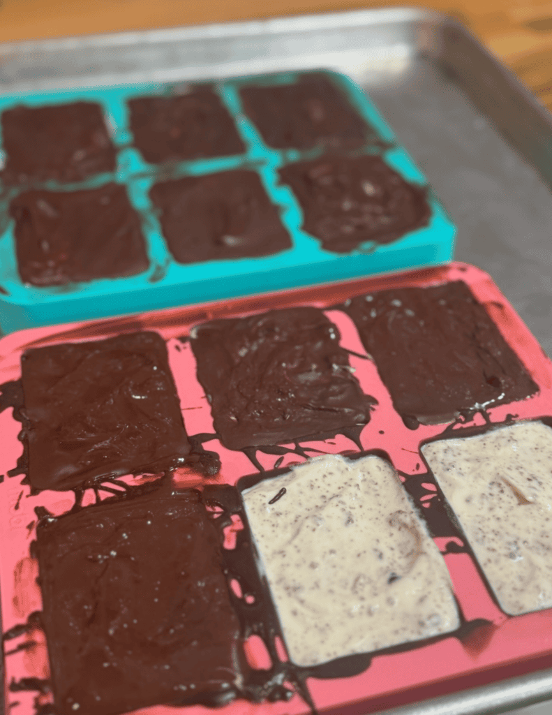 Delicious homemade chocolate fudge squares on colorful silicone molds. Perfect for desserts and swee.