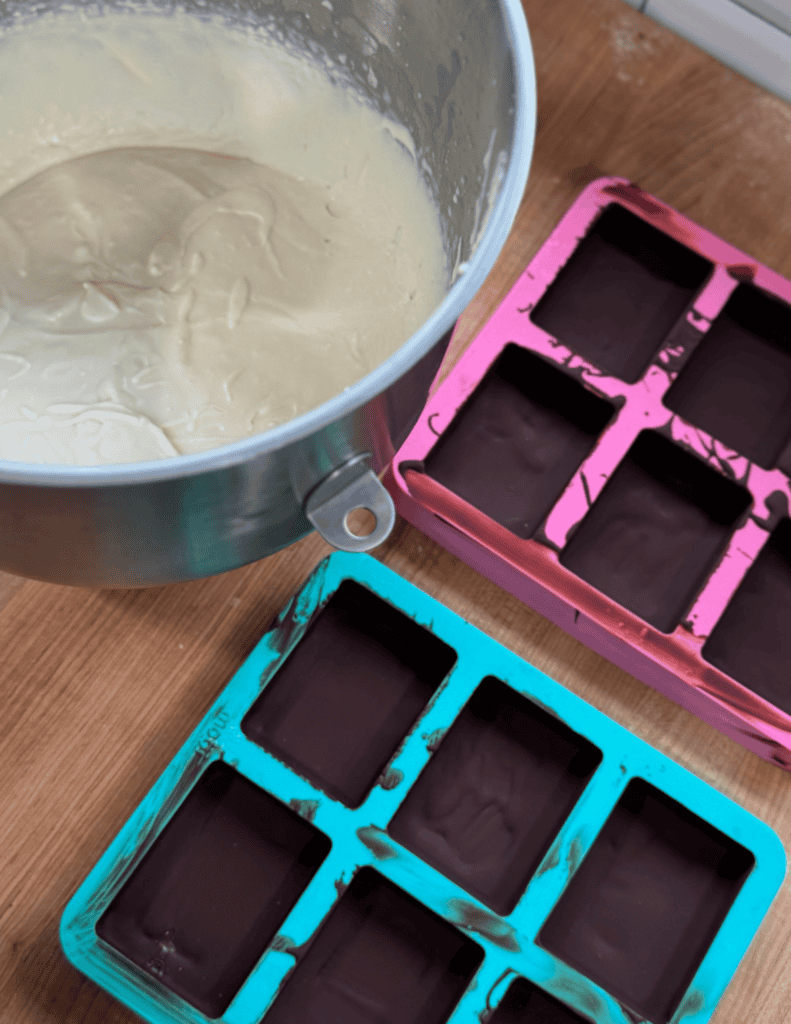 Delicious homemade ice cream being poured into colorful silicone molds for a fun family treat.