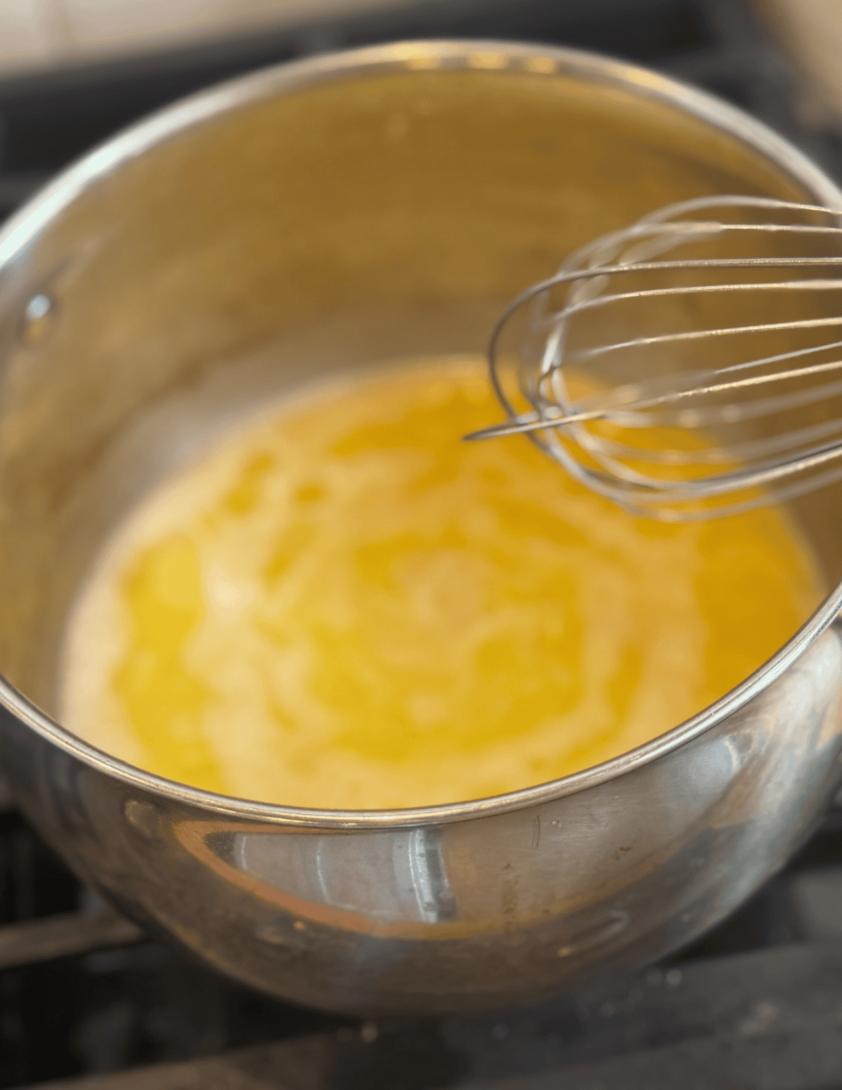 Melting butter in a stainless steel saucepan for cooking or baking.