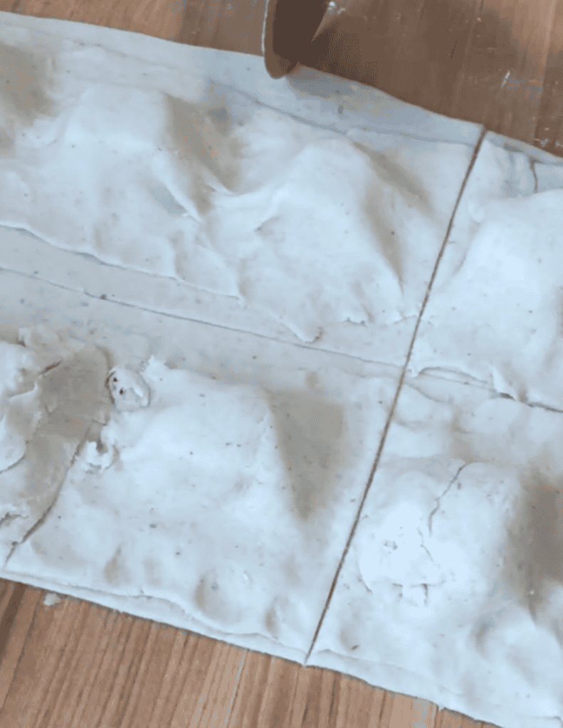 Fresh homemade dough for baking, on a wooden surface.