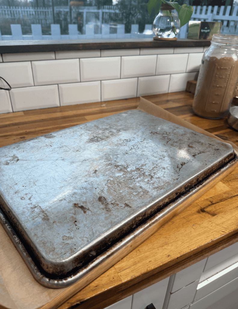 Baked goods tray on a wooden kitchen counter with baking ingredients in the background.