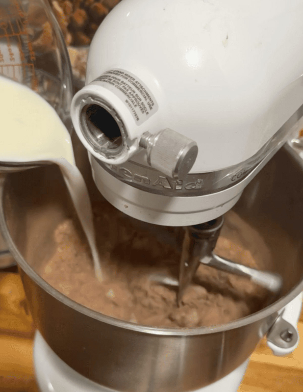 Mixer blending chocolate milkshake in a stand mixer for fresh farm-style dessert.