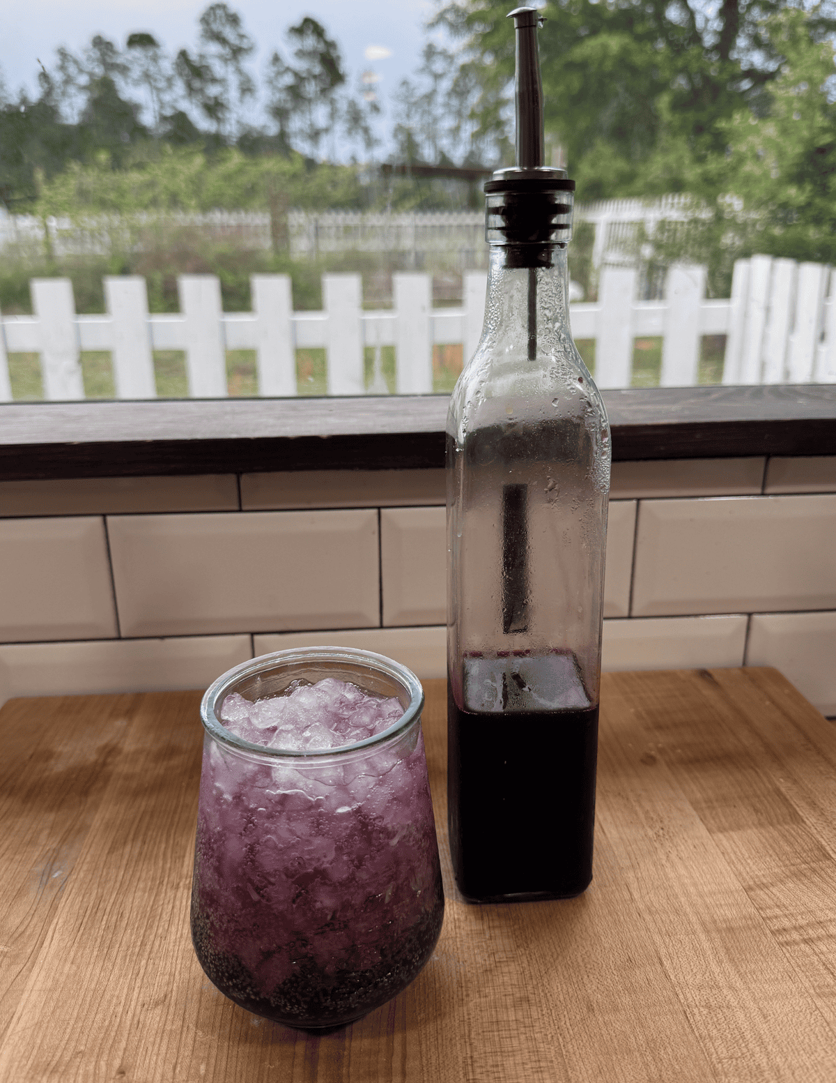 Fresh fruit syrup in a glass and bottle for beverages or desserts.
