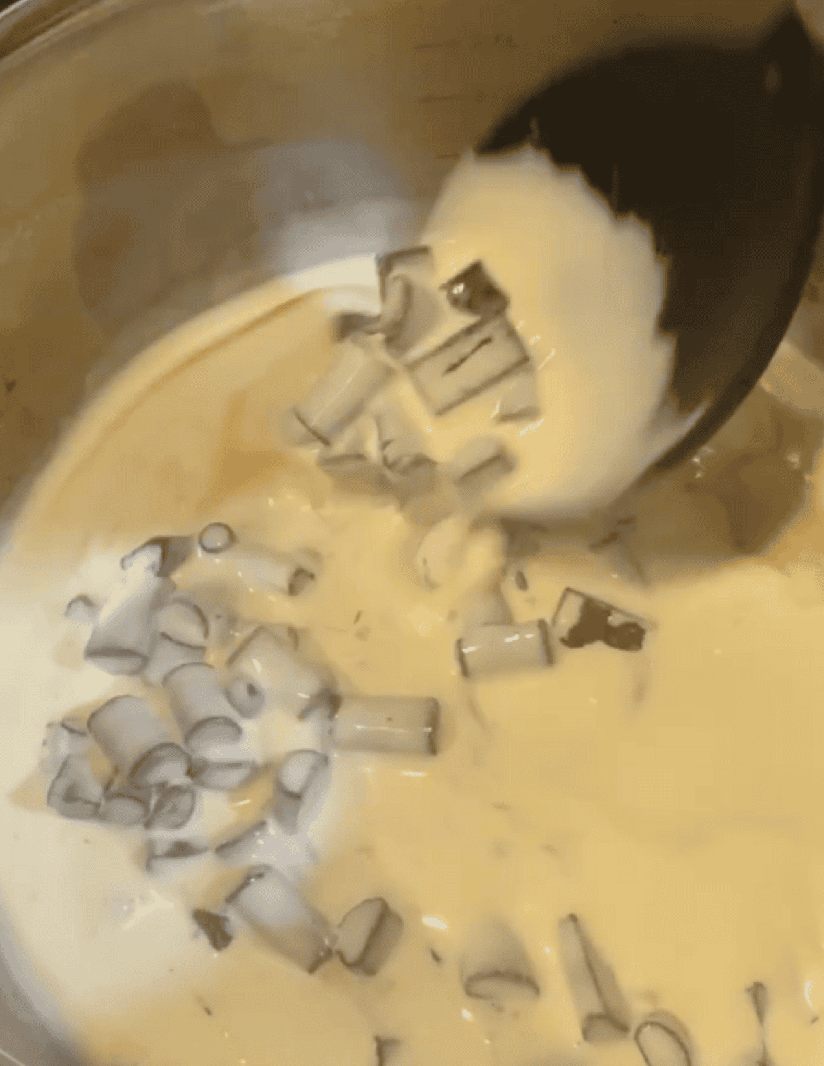 Chocolate and cream being cooked own into ganache.