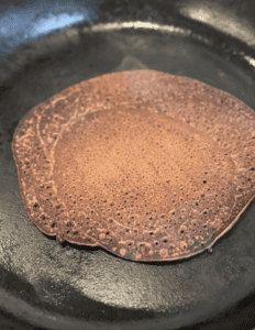 Freshly cooked pancake on a skillet, ready to serve.