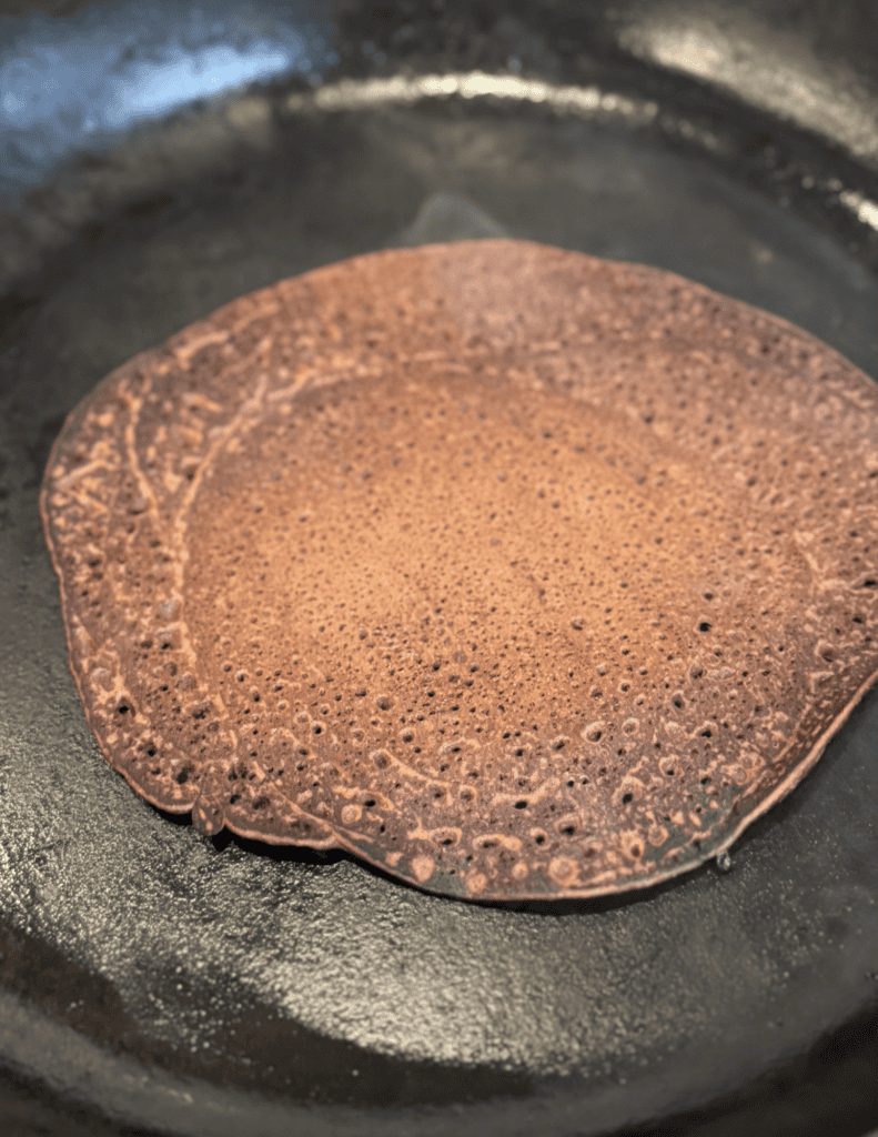 Freshly cooked pancake on a skillet, ready to serve.