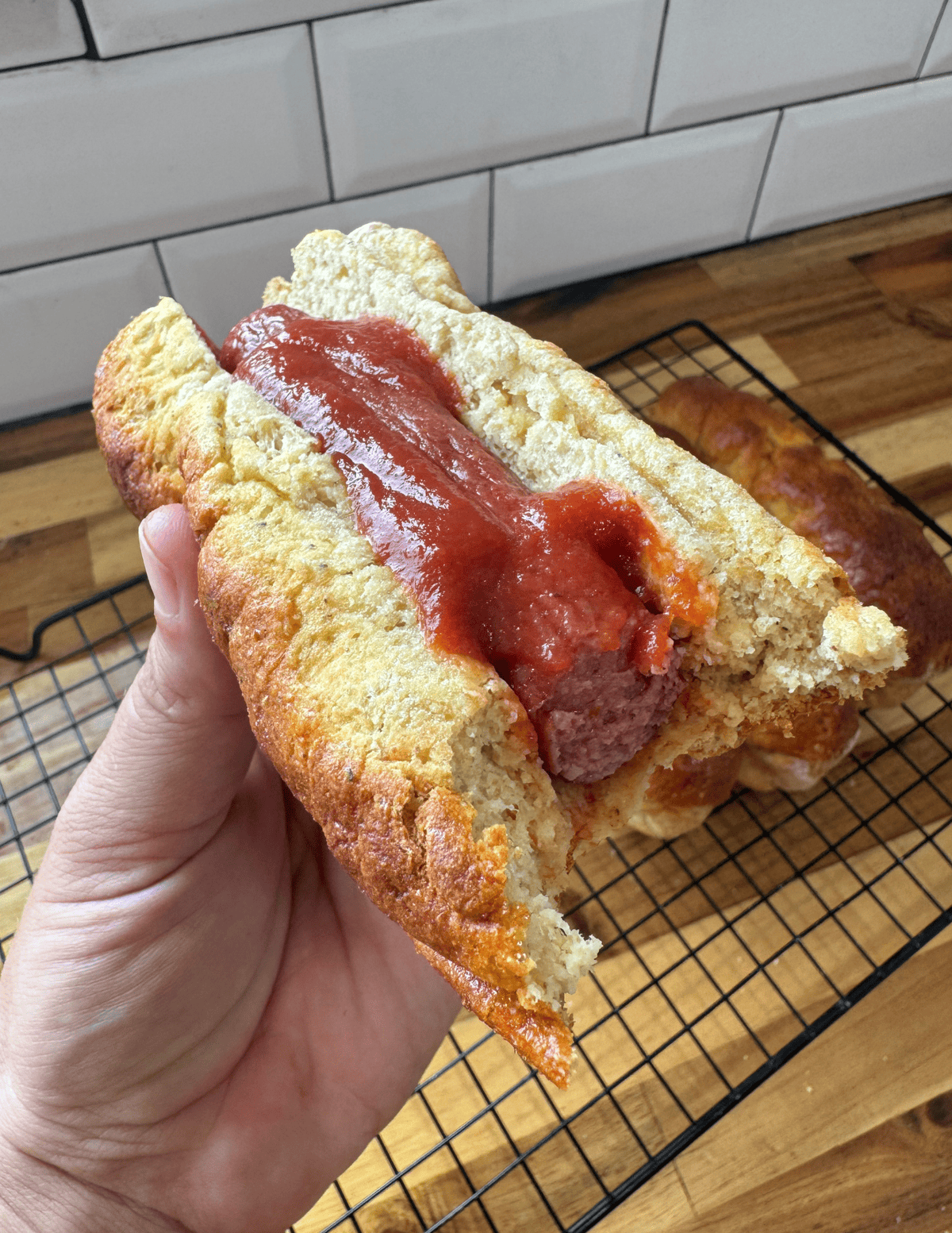 gluten free hot dog and bun with a bite taken out of it.