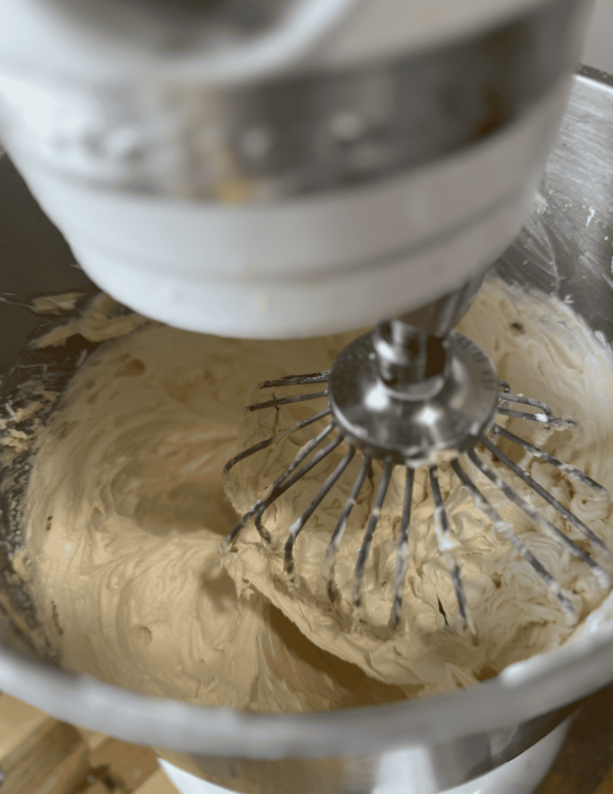 Fresh farm-made butter in a stand mixer with beaters.
