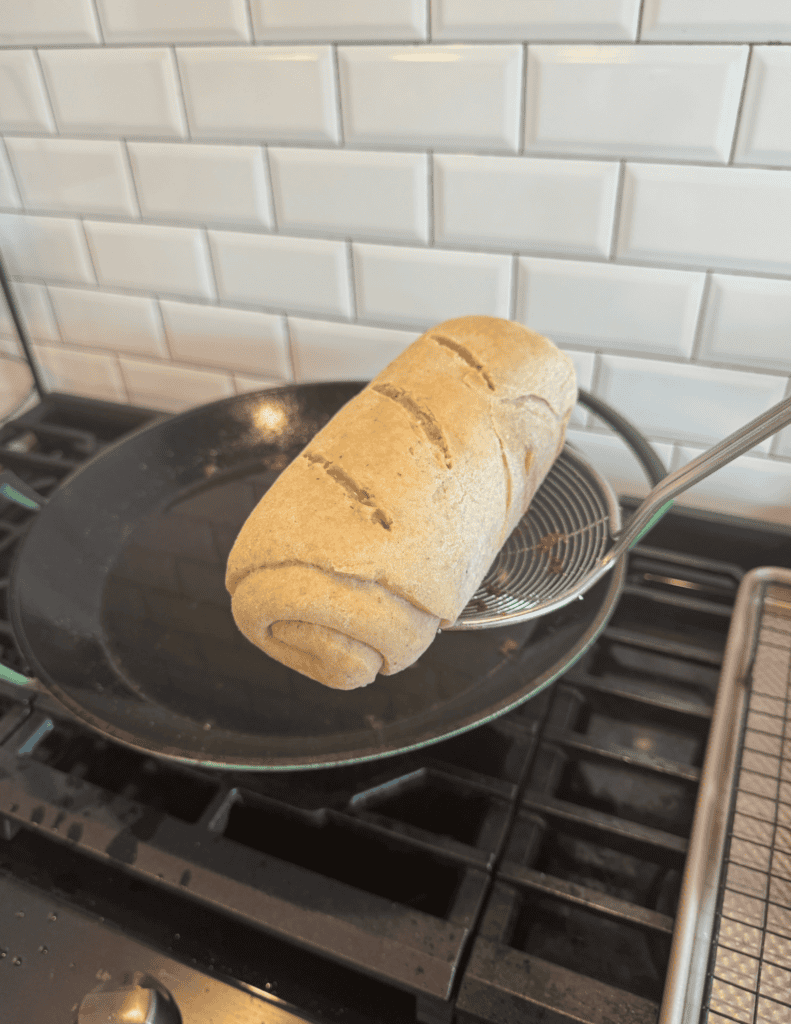 Freshly baked bread loaf on a skillet.
