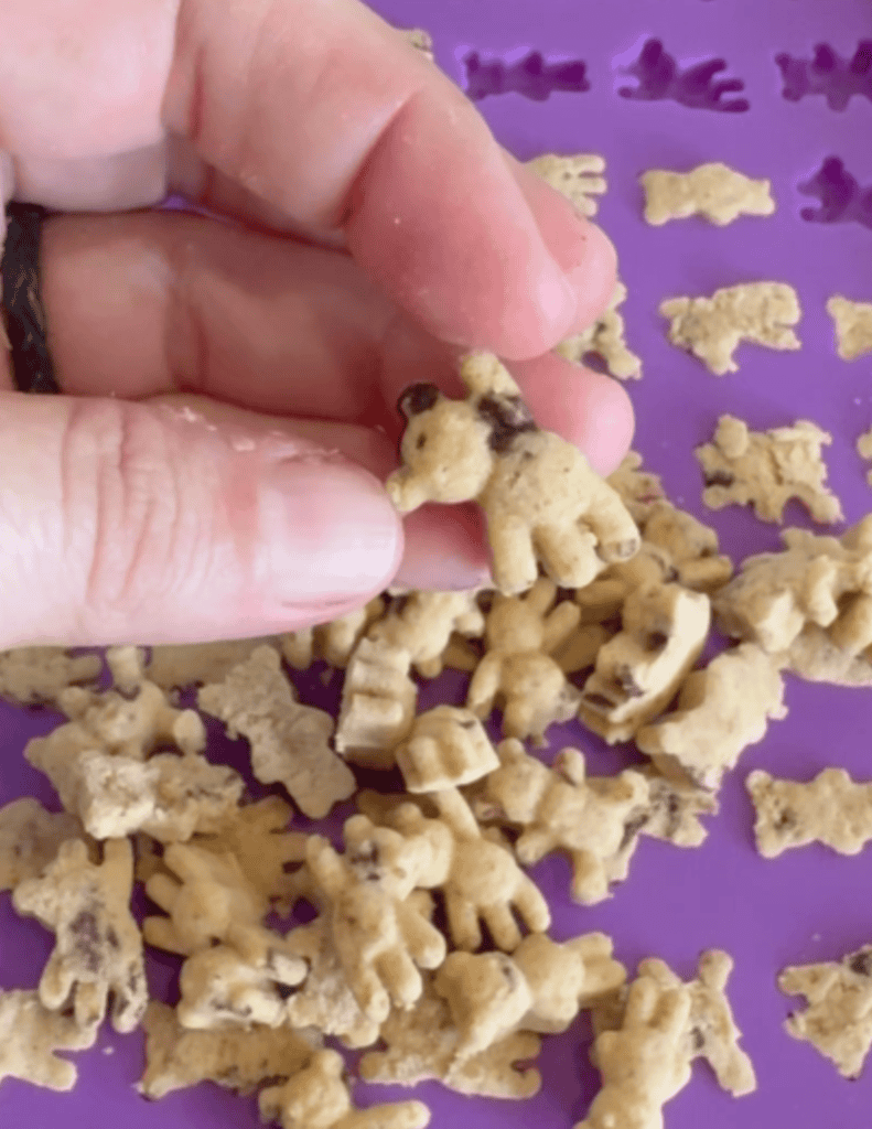 purple teddy graham mold with teddy grams in hand