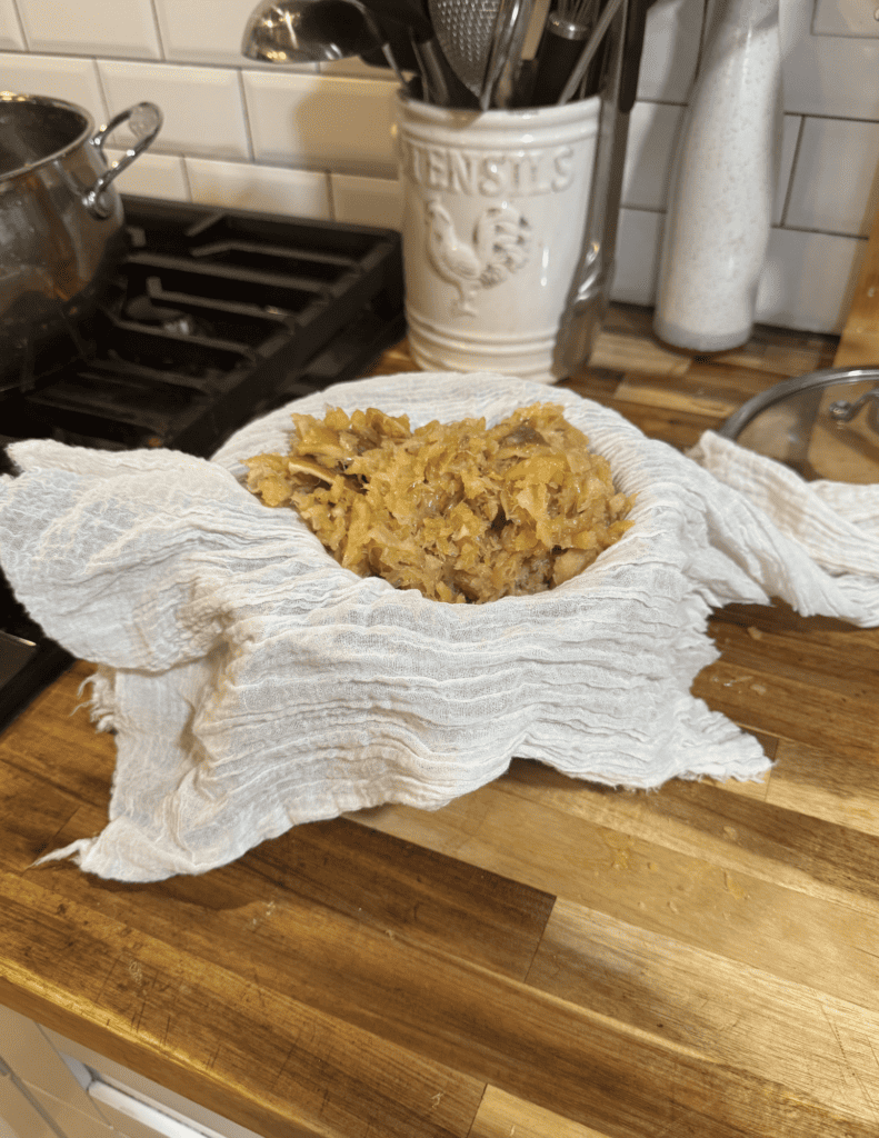 Freshly fried green tomatoes on a cloth on a wooden kitchen counter.
