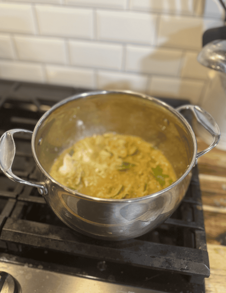 Healthy homemade vegetable soup in a stainless steel pot.