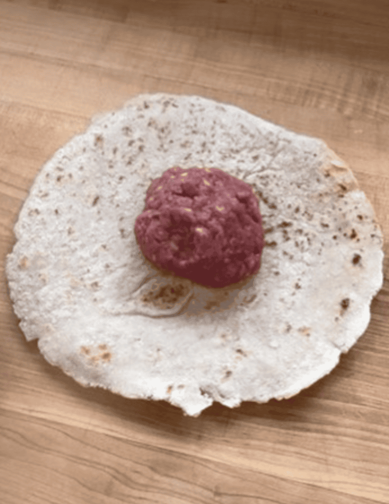 smash burger patty ball on a gluten free tortilla