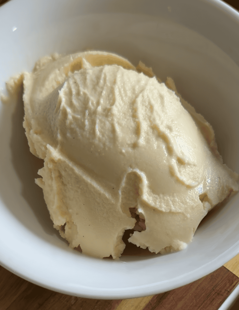 Creamy vanilla ice cream in a white bowl, fresh and delicious.