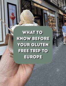 Hand holding ice cream cone in front of European cafe for gluten-free travel.