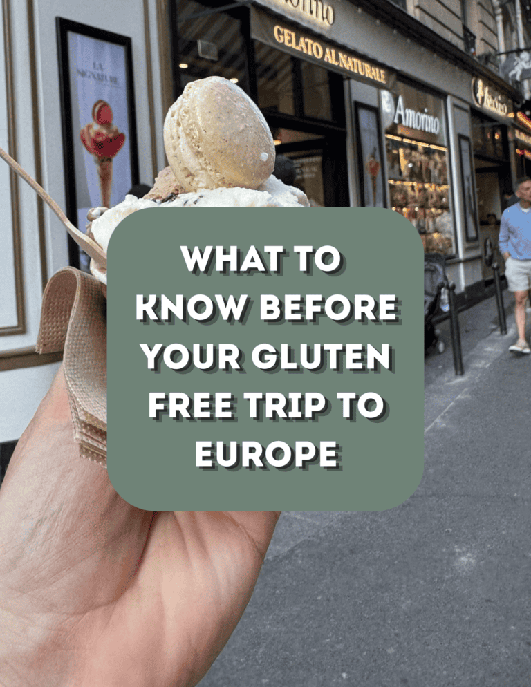Hand holding ice cream cone in front of European cafe for gluten-free travel.
