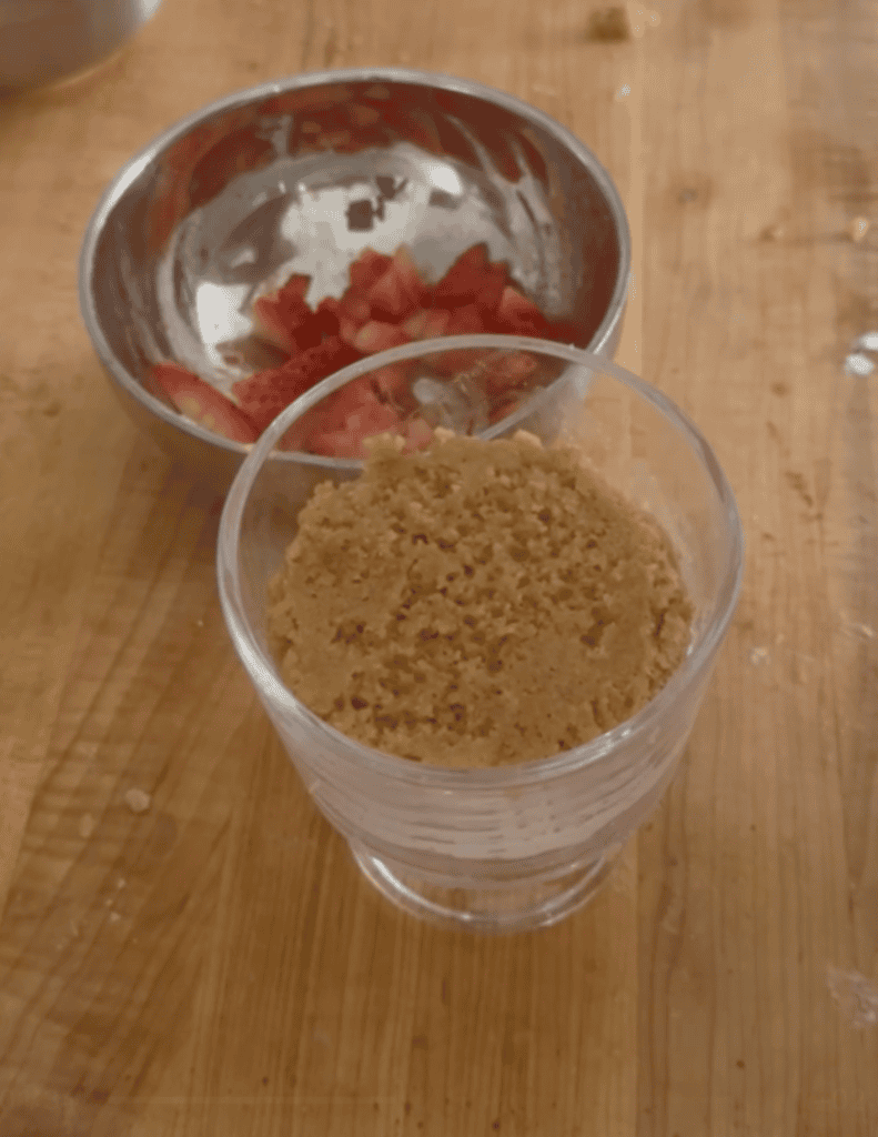 Fresh strawberries and graham cracker crumbs for strawberry trifle.